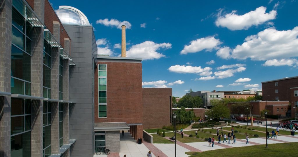 University science and tech buildings with individuals walking between them